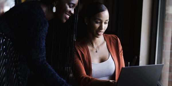 Colleagues learning together on a laptop